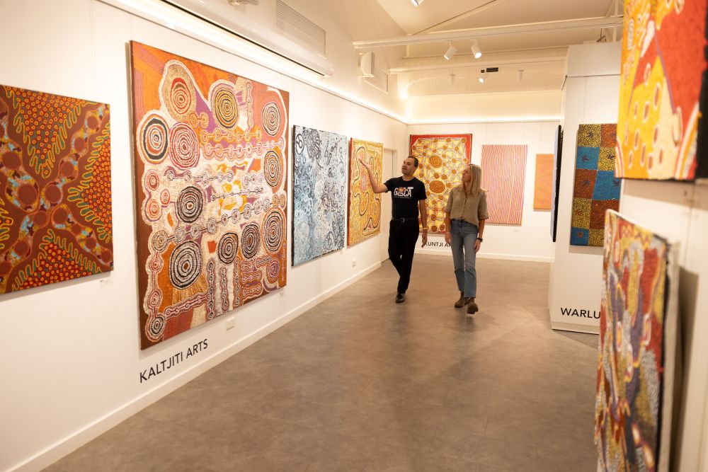 Two people admiring artwork