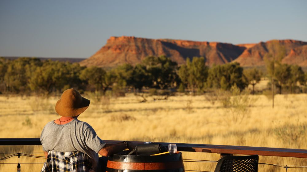 Person admiring Uluru at Kings Canyon