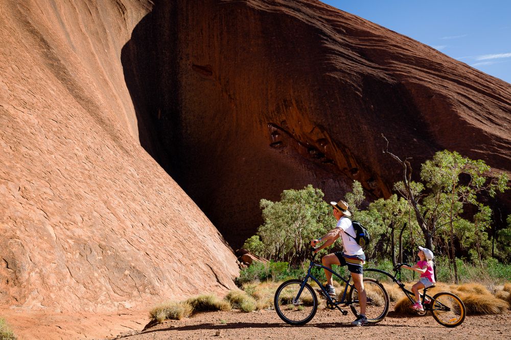 Two people cycling Uluru