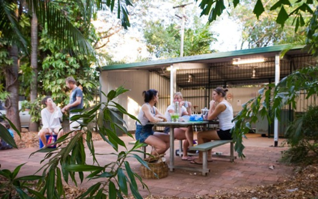 Top-Tips-For-Your-End-Of-Summer-Camping-Trip-people-sitting-at-table-eating-outside