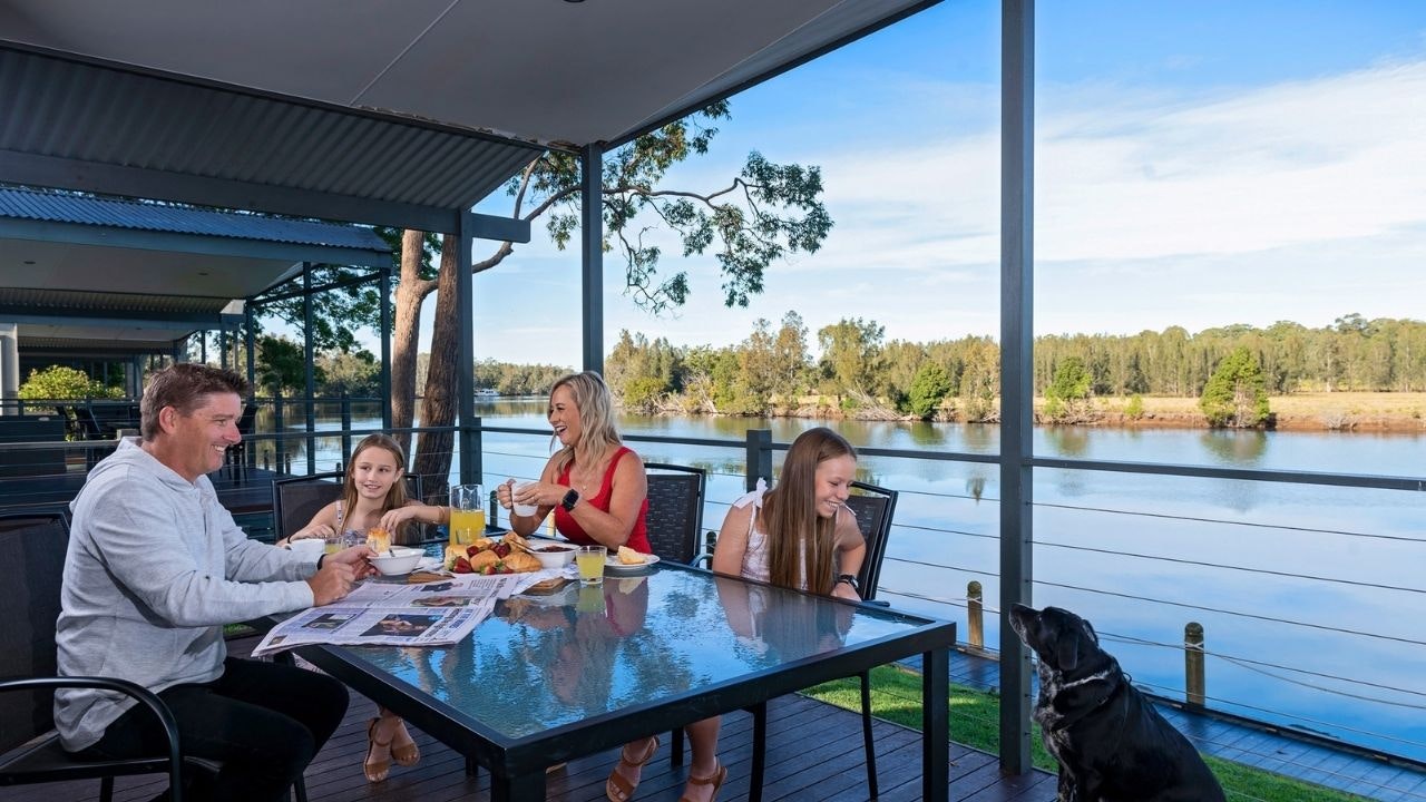A family enjoying a meal with their pet at Discovery Park